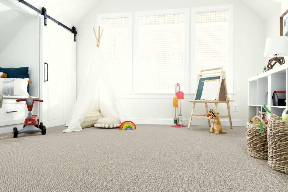 gray looped carpet in modern kids room with barn door detail